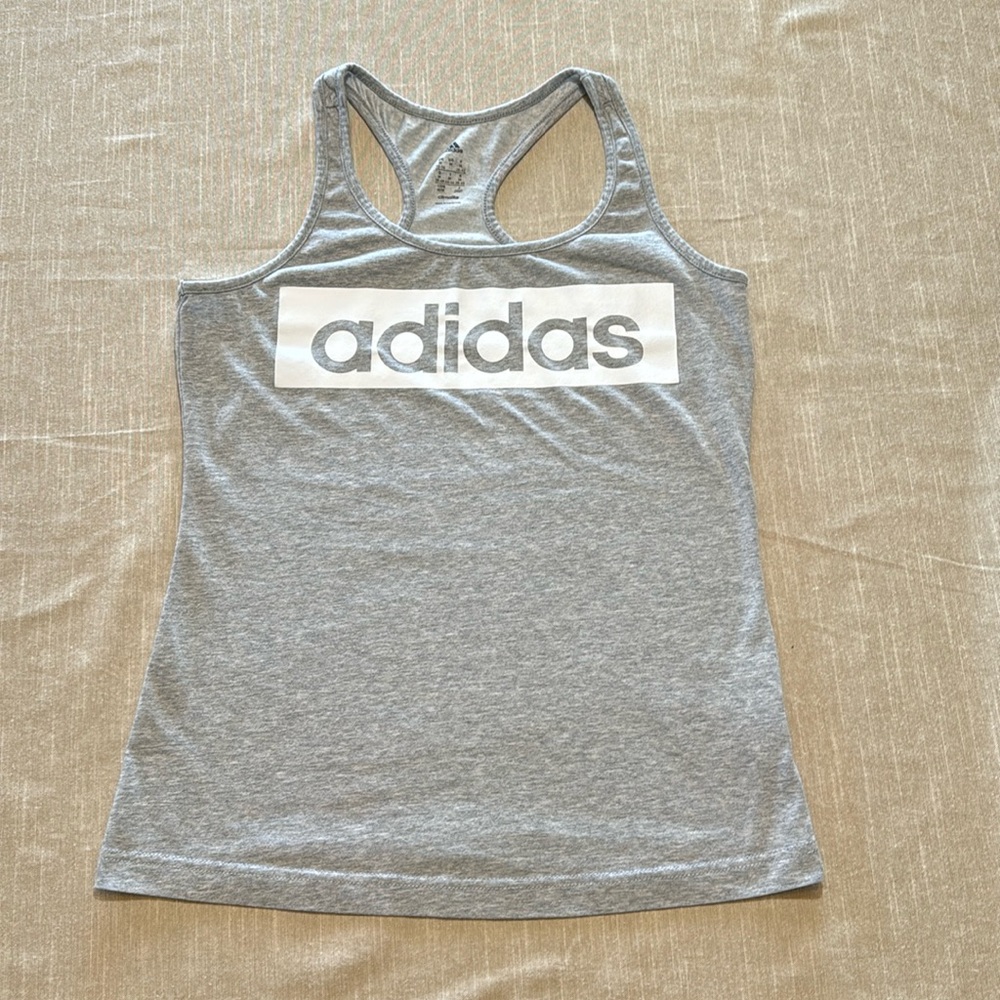 Adidas  Heather gray with white print, razor back and is climalite. Size Medium